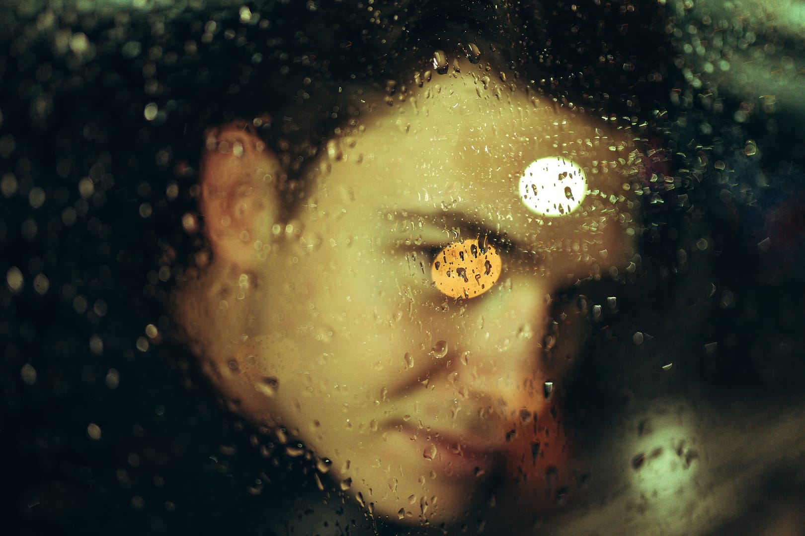 Male model in side car behind rainy window