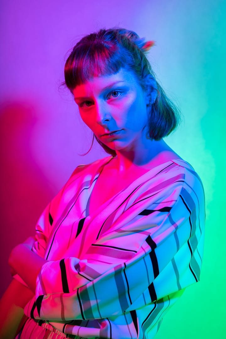 Woman model in studio, red green blue colors mixed